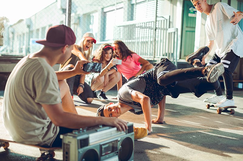 Young people break dancing in a parking lot